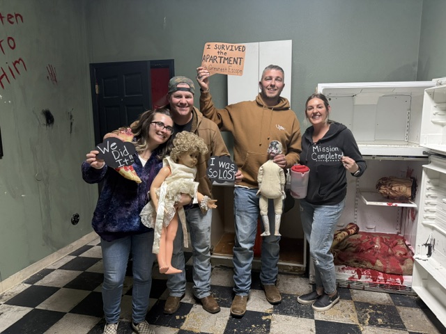 Players celebrating in The Apartment escape room