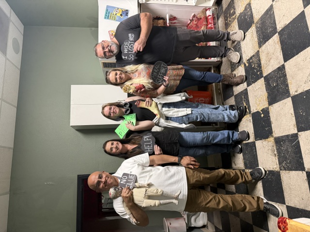 Greatest Escape team holding celebration signs